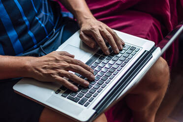 Close-up of a using his laptop in the quarantine period - CAVF81116