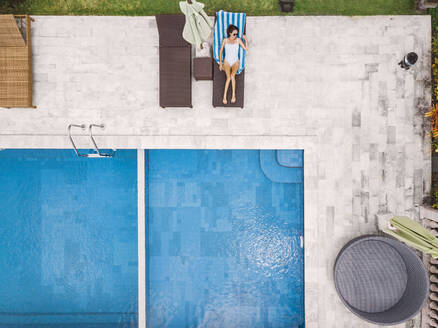 Aerial view of attractive woman near the pool at resort - CAVF81144