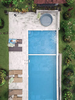 Aerial view of attractive woman near the pool at resort - CAVF81145