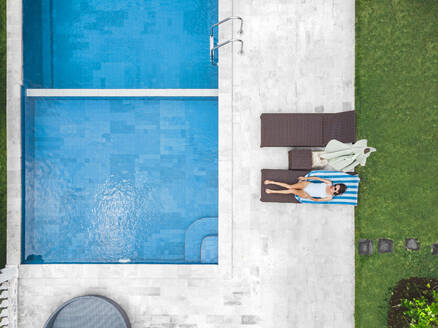 Aerial view of attractive woman near the pool at resort - CAVF81147