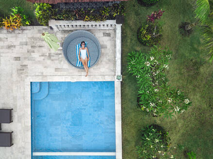 Aerial view of attractive woman near the pool at resort - CAVF81154