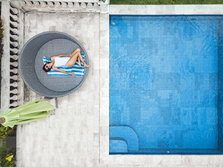 Aerial view of attractive woman near the pool at resort - CAVF81159