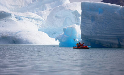 2 men traveling with a sea kayak in Eastern Greenland - CAVF81245