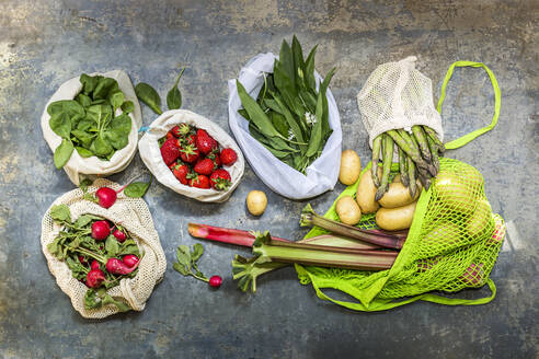 Studio shot of mesh bags with various fruits and vegetables - STBF00543