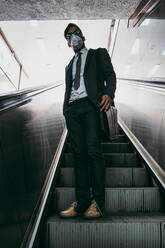 Business man standing on city street with protective face mask. - CAVF81376