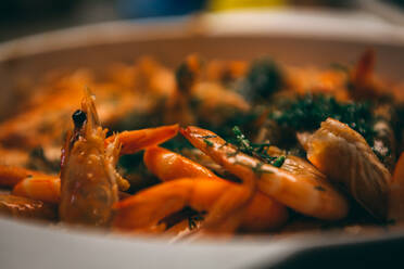 Fried until golden brown tiger shrimp are ready in a pan and serving at the table - CAVF81391