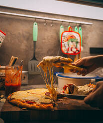 Selektiver Fokus auf italienische Pizza, Gewürze in Mühlen, Flasche und Glas Wein auf Holztischplatte - CAVF81404