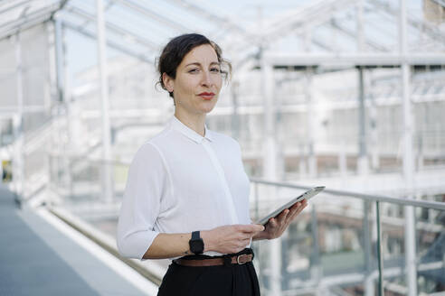 Portrait of a confident businesswoman holding tablet - JOSEF00707