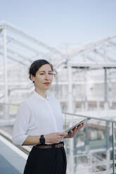 Portrait of a confident businesswoman holding tablet - JOSEF00708