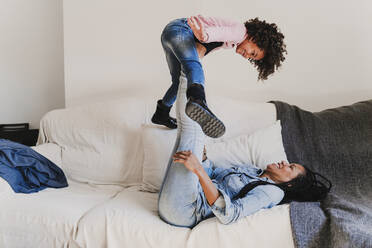 Mother and her little daughter playing together at home - EBBF00089