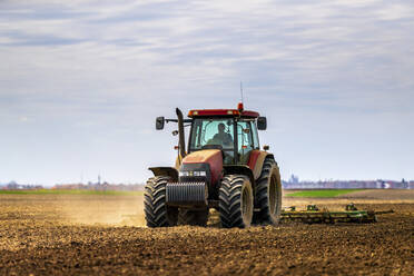 Landwirt im Traktor pflügt Feld im Frühling - NOF00091