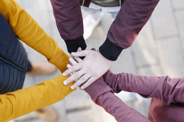 Close-up of friends stacking their hands - JCZF00098