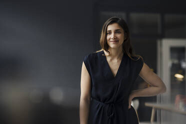 Portrait of smiling young businesswoman in a loft - JOSEF00752