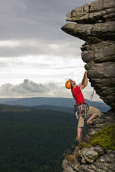 Rock climber on cliff at the Peak District in England - CAVF81720