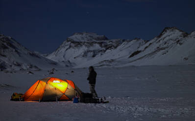 Illuminated tent at camp in the Icelandic winter landscape - CAVF81900