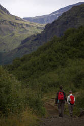 Couple walking through a valley on the Laugavegur trail - CAVF81930