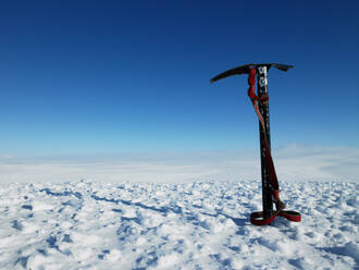 Ice pick stuck in snow on top of a mountain - CAVF81947