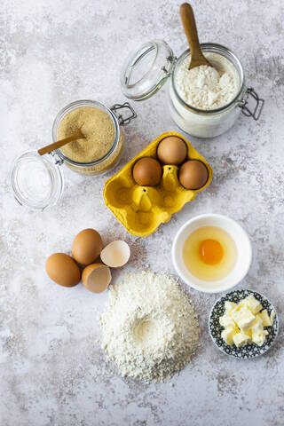 Butter, chicken eggs and jars of flour and brown sugar stock photo