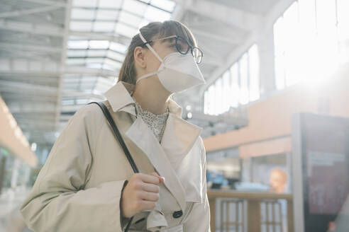 Portrait of woman wearing face mask in a shopping center - AHSF02603