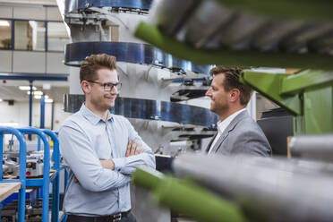 Two businessmen talking in factory - DIGF11108