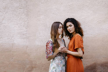 Portrait of two young women holding hands - TCEF00660