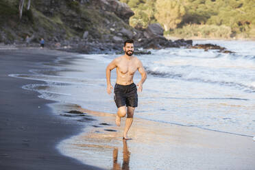 Gut aussehend shirtless Mitte Erwachsenen Mann läuft am Strand bei Sonnenuntergang - LJF01519