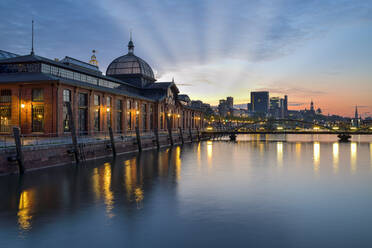 Germany, Hamburg, Fish auction hall on Elbe river at sunrise - RJF00830