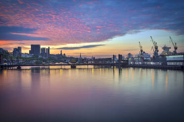 Germany, Hamburg, Cloudscape above Harbor with Altona fish market at sunrise - RJF00831