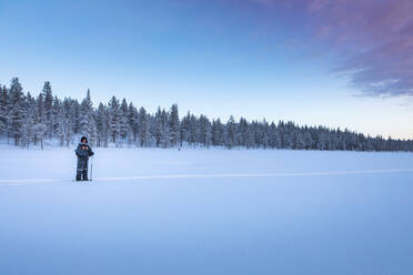 Snow shoe hiker in winter landscape, Sotkajarvi, Enontekioe, Finland - WVF01554