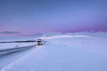 Truck on country road in winter, Tana, Norway - WVF01579