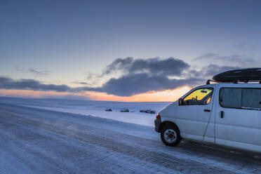 Camper van on country road in winter, Tana, Norway - WVF01581