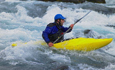 Man going on his white water kayak rapids in an Icelandic river - CAVF82143