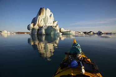 Stern of a sea kayak floating towards an iceberg on a glacier lagoon - CAVF82146