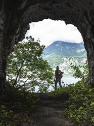 Explorer standing at cave entrance - MCVF00392