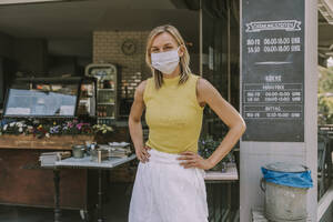 Portrait of confident cafe owner wearing face mask - MFF05675