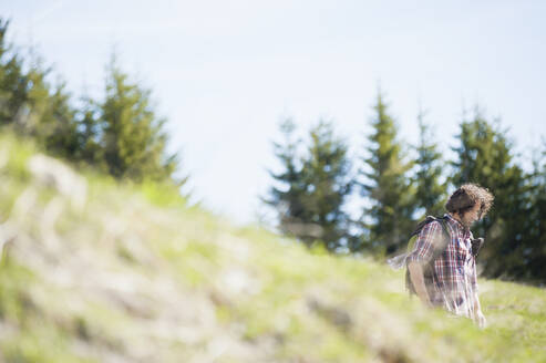 Hiking man on meadow, Wallberg, Bavaria, Germany - DIGF11669