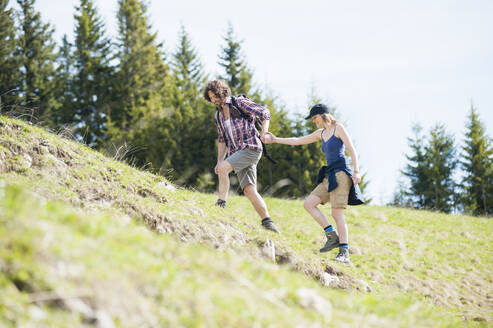 Hiking couple on meadow in summer, Wallberg, Bavaria, Germany - DIGF11670