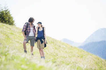 Hiking couple on meadow in summer, Wallberg, Bavaria, Germany - DIGF11672