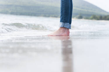 Woman's feet at seashore, Sardinia, Italy - DIGF11700