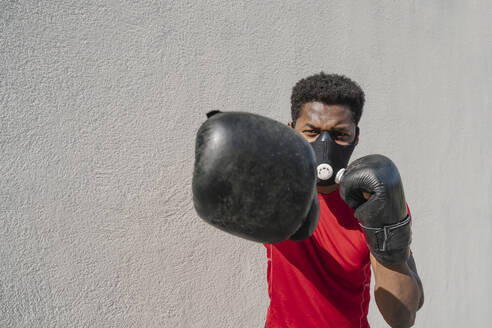 Portrait of a sportsman wearing face mask and boxing - AHSF02680