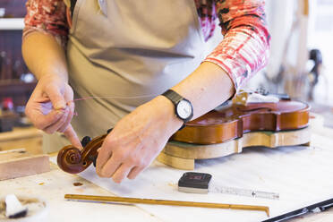 Female violin maker at work - DIGF11887