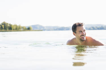 Porträt eines jungen Mannes beim Baden im See - DIGF11946