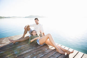 Young couple relaxing on jetty - DIGF11960