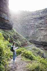 Female hiker with map, Tenerife, Balearic Islands, Spain - DIGF12126