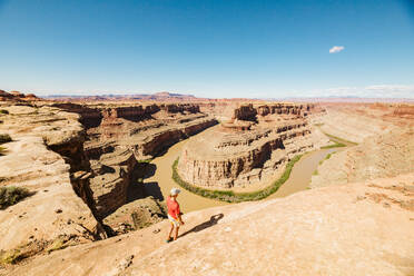 Female hiker takes in the view above the green river confluence utah - CAVF82493