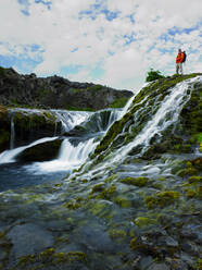 Man standing above beautiful waterfall at Thjorsardalur - CAVF82745