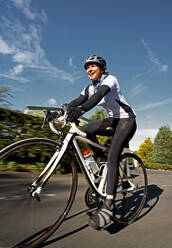 Blurred shot of a female cyclist in the British Lake District - CAVF82791