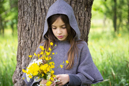Girl picking yellow wildflowers - LVF08911