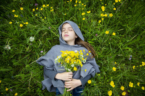 Girl picking yellow wildflowers - LVF08914