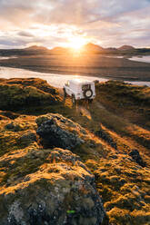 4x4 Truck looks out over sunrise landscape in Iceland - CAVF82959